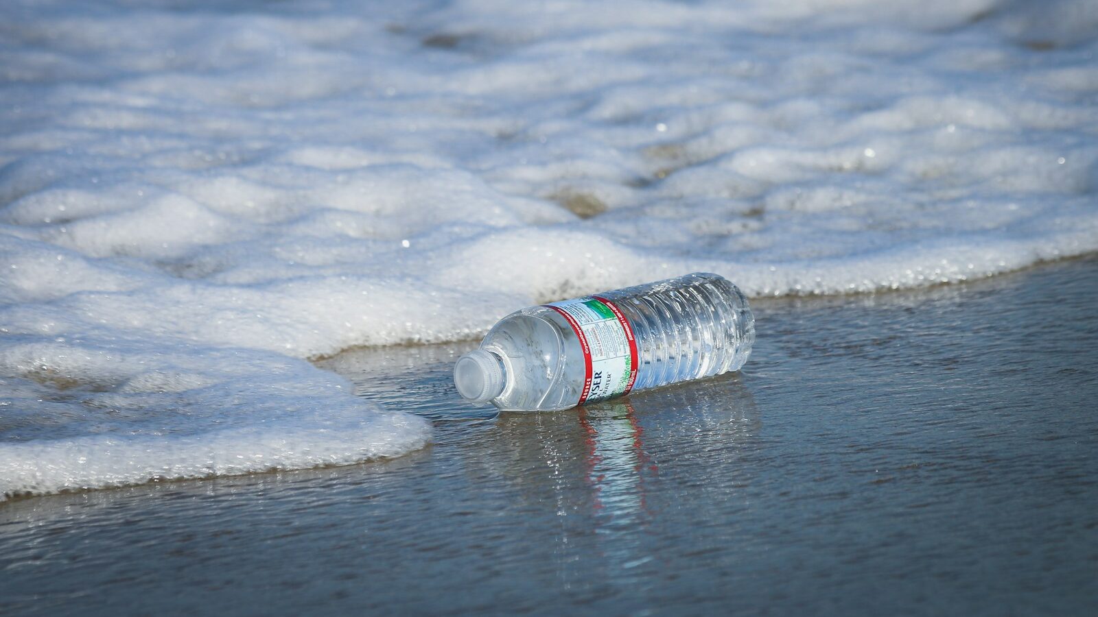 water plastic bottle on seashore